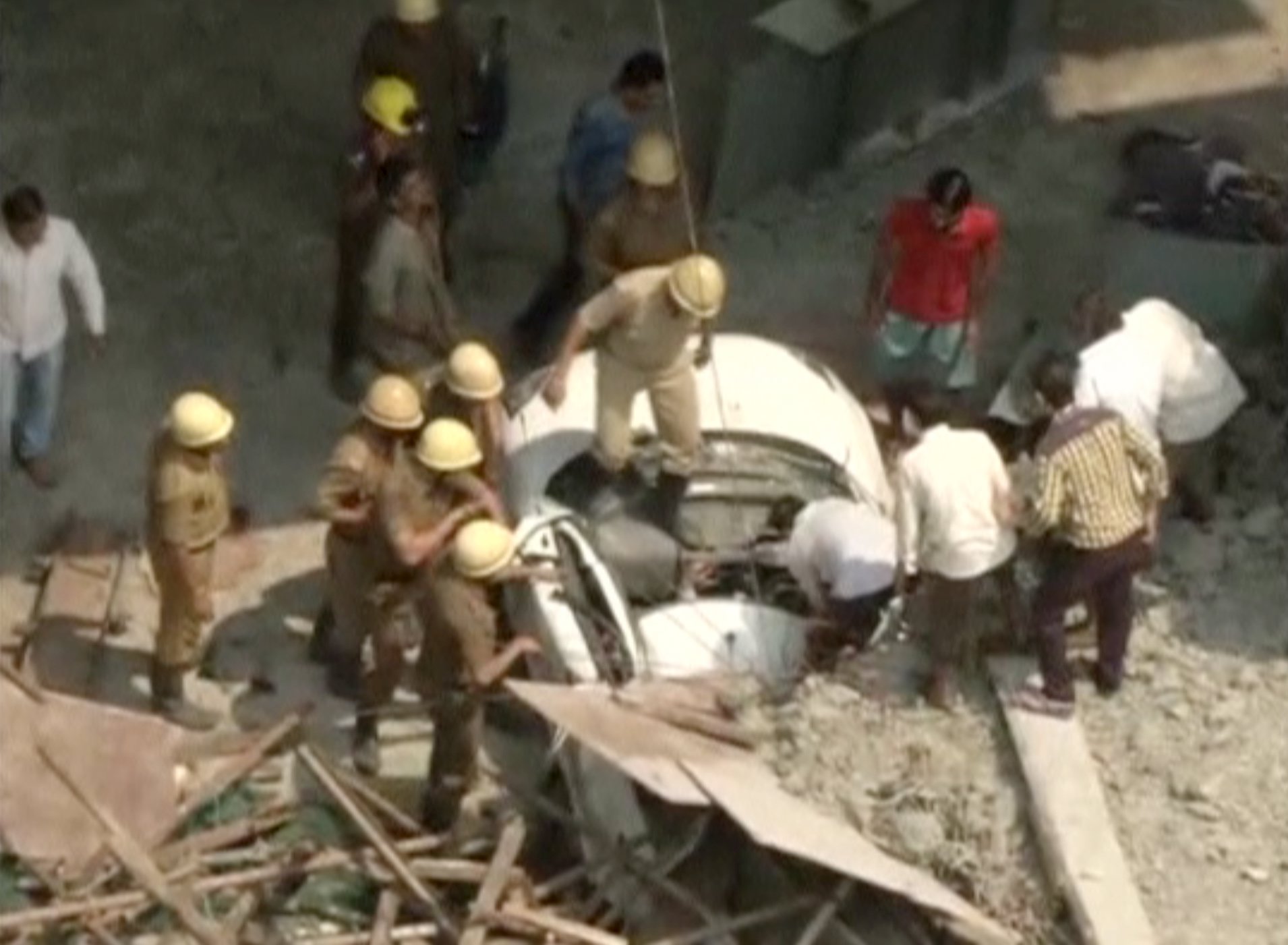 Collapsed Prson Rescue workers attempt to rescue a person trapped in a car after a ...